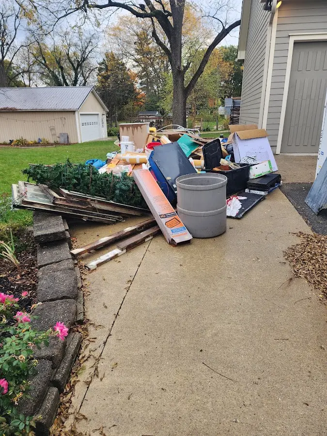 Dumpster being loaded with debris for Demolition Dumpster Rental in Kewaskum